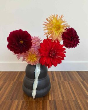 Black vase with white-blue swirl glaze